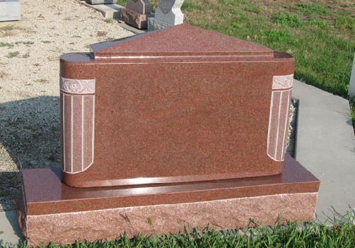 Red granite upright monument with carved column detail down each side