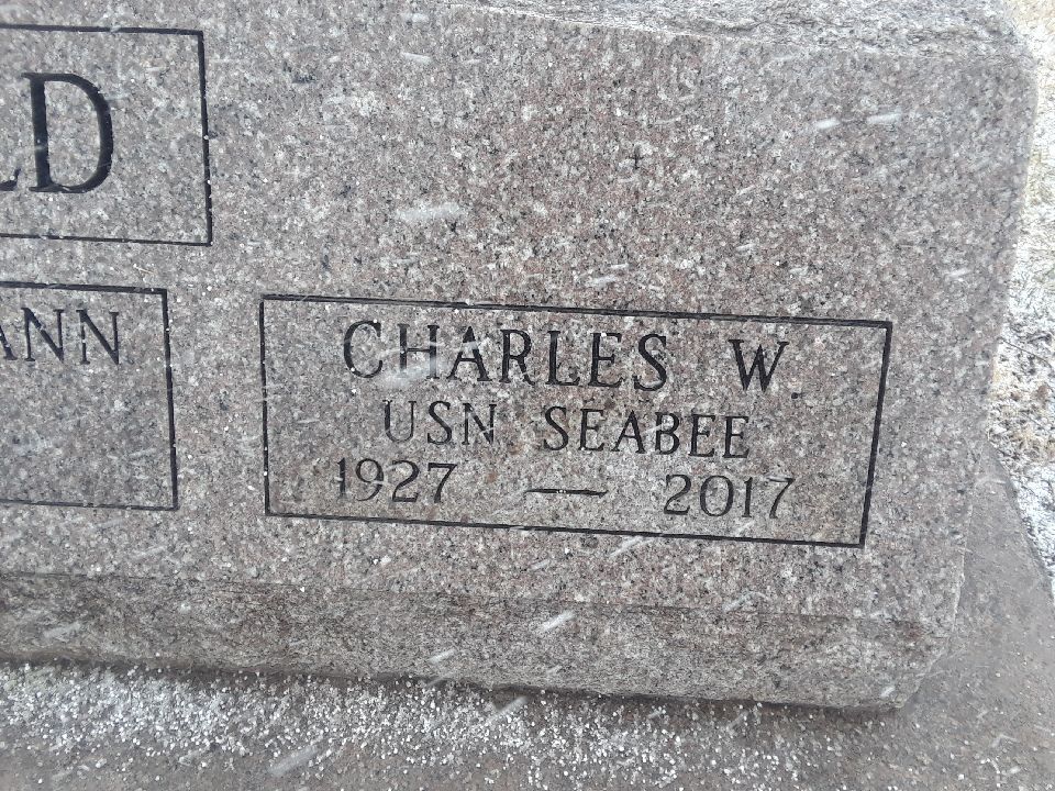 Close up of a final date newly cut into an existing granite monument, reading USN Seabee, 1927 to 2017