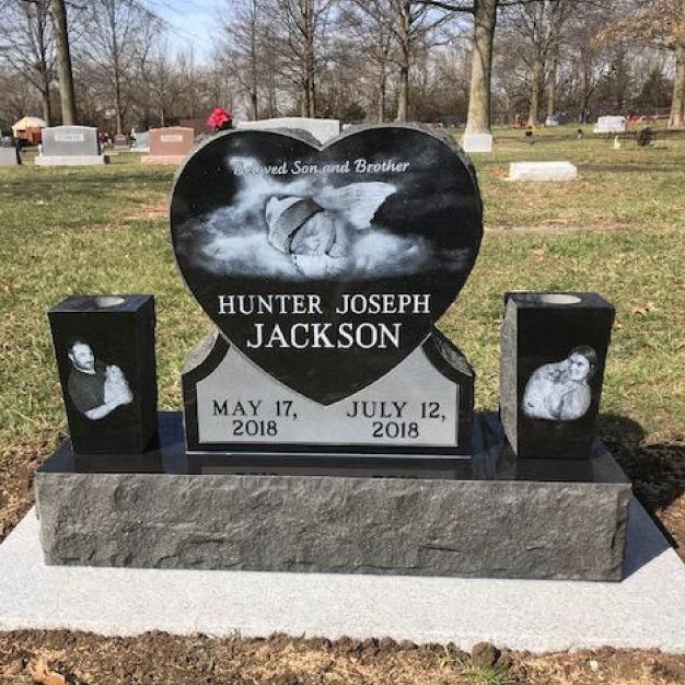 Black granite heart monument with laser etched portrait panels on the twin vases either side